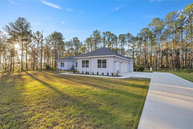 view of front of house with a garage and a front lawn