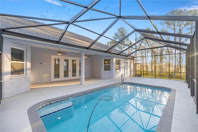 view of swimming pool featuring ceiling fan, a patio area, a lanai, and french doors