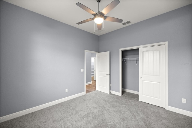 unfurnished bedroom with ceiling fan, a closet, and carpet