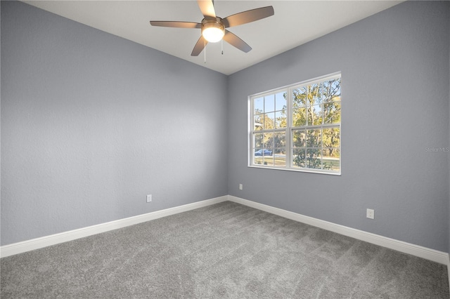 empty room featuring ceiling fan and carpet floors