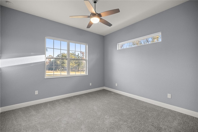 carpeted spare room featuring ceiling fan