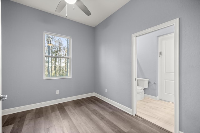 empty room with ceiling fan and hardwood / wood-style floors