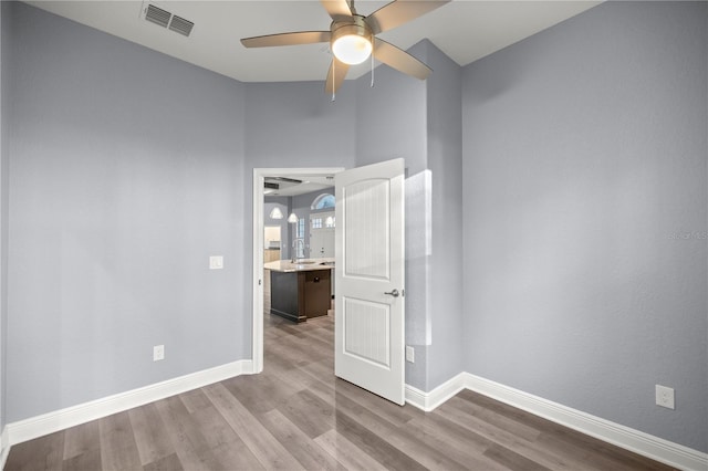 spare room featuring light hardwood / wood-style floors and ceiling fan