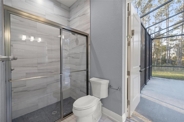 bathroom featuring toilet and a shower with door