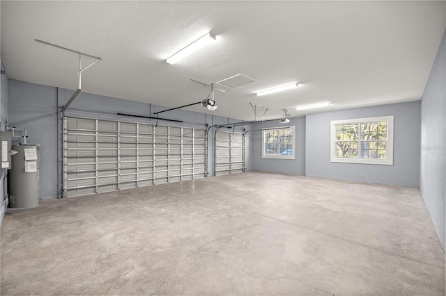 garage featuring water heater and a garage door opener