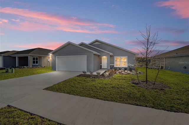 single story home featuring a garage and a yard