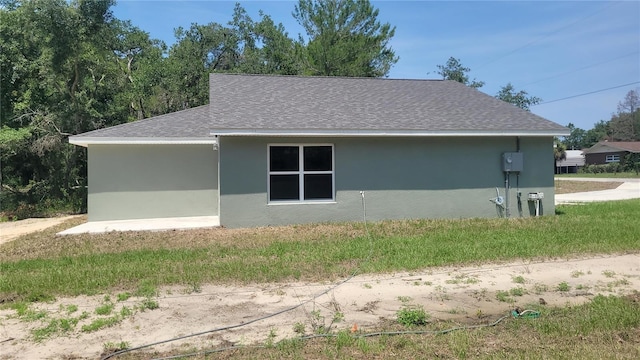 24300 SW Sea Cliff Ave, Dunnellon, FL 34431 - view of side of home with stucco siding and roof with shingles