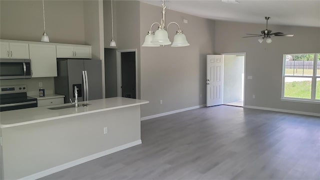 24300 SW Sea Cliff Ave, Dunnellon, FL 34431 - kitchen with stainless steel appliances, light countertops, high vaulted ceiling, open floor plan, and wood finished floors