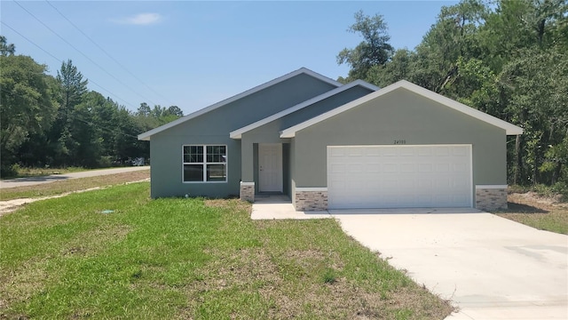 24300 SW Sea Cliff Ave, Dunnellon, FL 34431 - view of front of home with a garage, a front lawn, concrete driveway, stucco siding, and stone siding