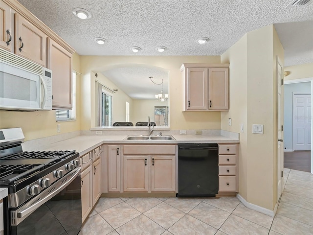 kitchen with white microwave, light brown cabinets, a sink, dishwasher, and stainless steel range with gas stovetop