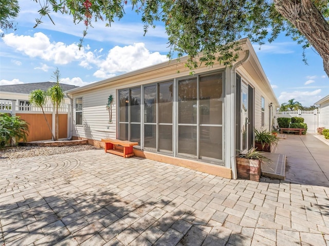 back of property with a patio area and fence