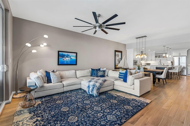 living room with ceiling fan and light hardwood / wood-style floors