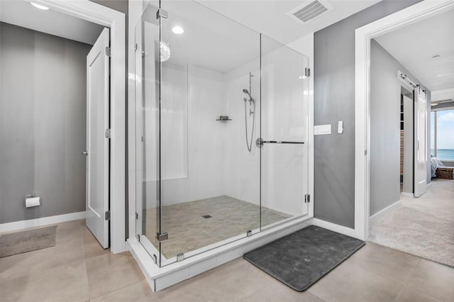 bathroom with tile patterned flooring and an enclosed shower