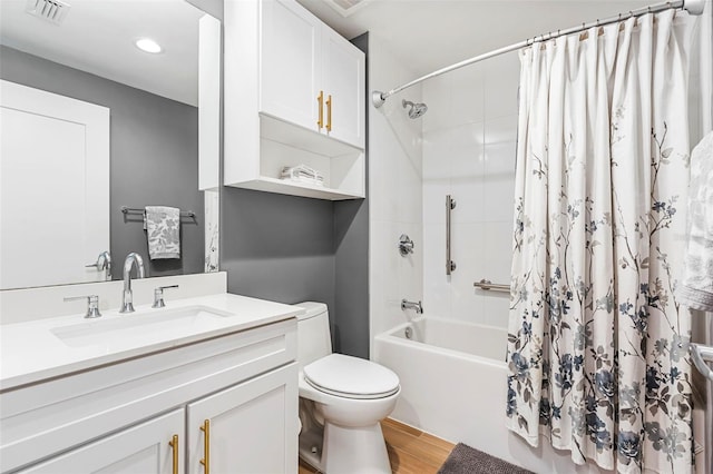 full bathroom featuring hardwood / wood-style floors, vanity, toilet, and shower / tub combo with curtain