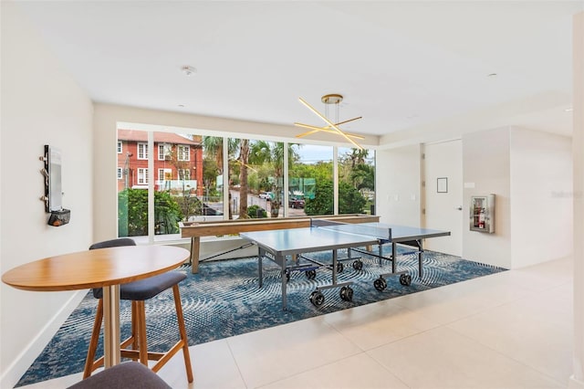 tiled dining room featuring an inviting chandelier