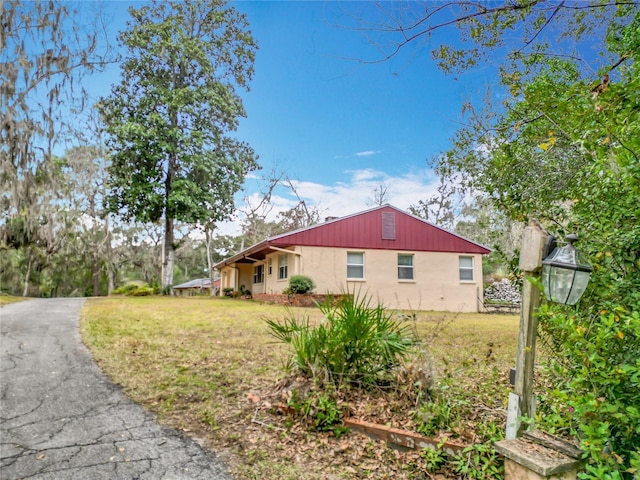 view of home's exterior with a yard