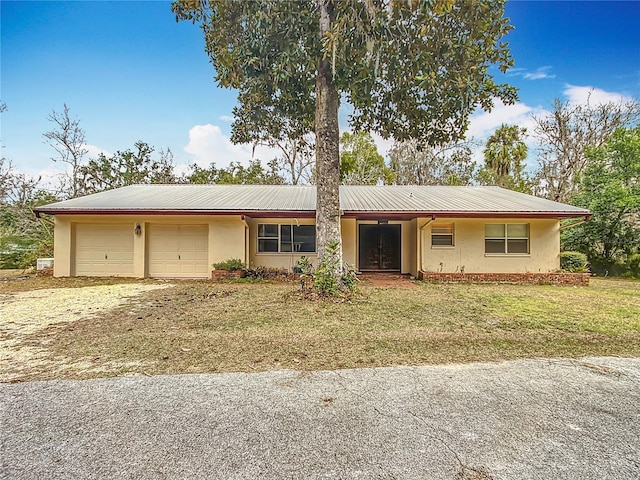 single story home featuring a front yard and a garage