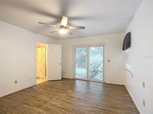 empty room with ceiling fan and dark wood-type flooring