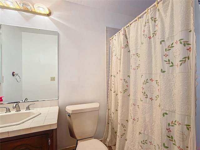 bathroom featuring toilet and vanity