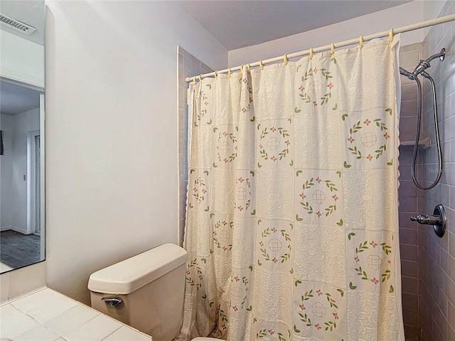 bathroom with toilet and a shower with curtain