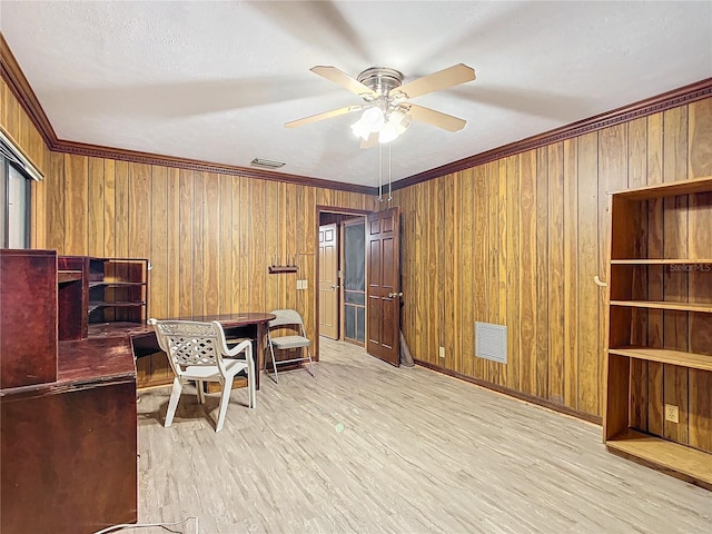 home office featuring ceiling fan, light wood-type flooring, and crown molding