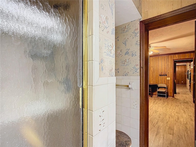 bathroom with ceiling fan and a shower with shower door