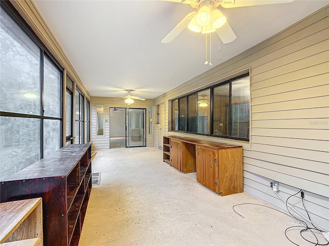 sunroom featuring ceiling fan