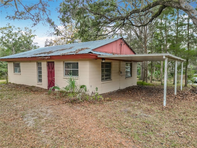 view of home's exterior with a carport