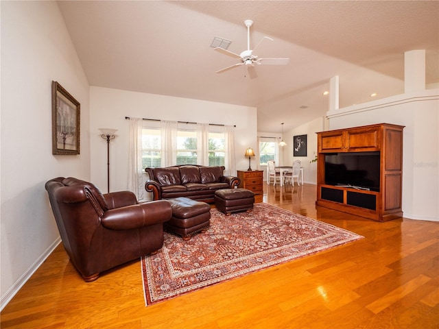 living room with ceiling fan, vaulted ceiling, light hardwood / wood-style flooring, and a wealth of natural light