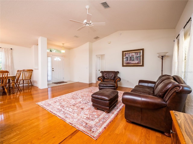 living room featuring lofted ceiling, hardwood / wood-style floors, and ceiling fan