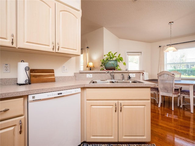 kitchen featuring dark hardwood / wood-style floors, sink, hanging light fixtures, white dishwasher, and kitchen peninsula