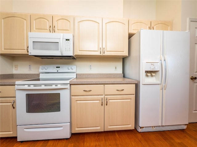 kitchen with white appliances and wood-type flooring