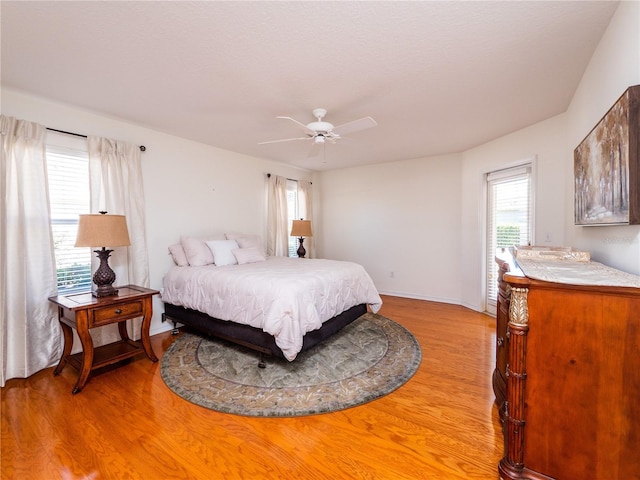 bedroom with light wood-type flooring and ceiling fan