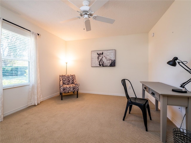 home office featuring light colored carpet and ceiling fan