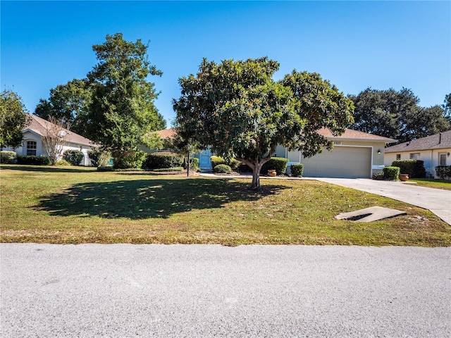 single story home featuring a garage and a front yard