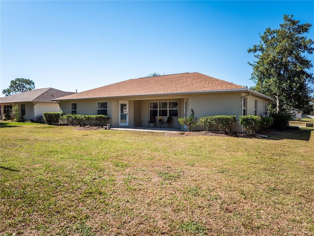 back of house with a yard and a patio area