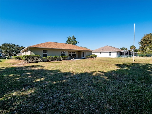 rear view of house with a lawn