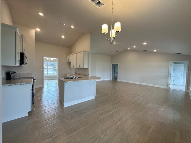 kitchen featuring a chandelier, hanging light fixtures, white cabinetry, appliances with stainless steel finishes, and sink