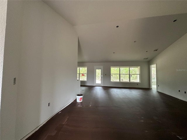 unfurnished living room with lofted ceiling