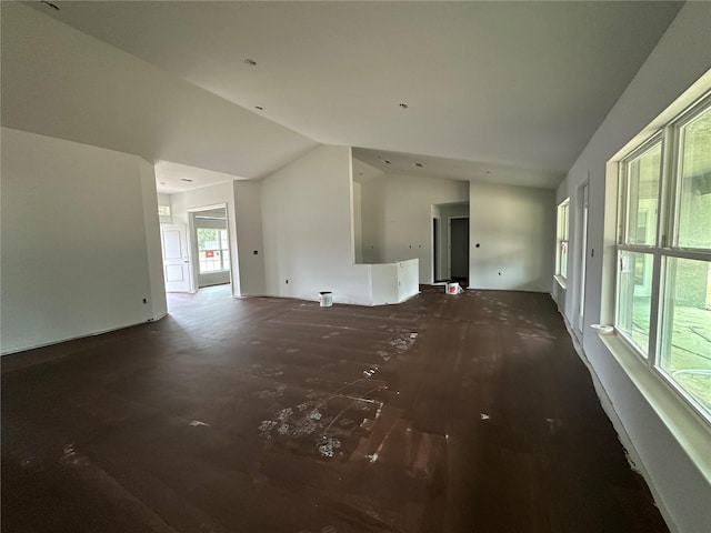 unfurnished living room featuring vaulted ceiling