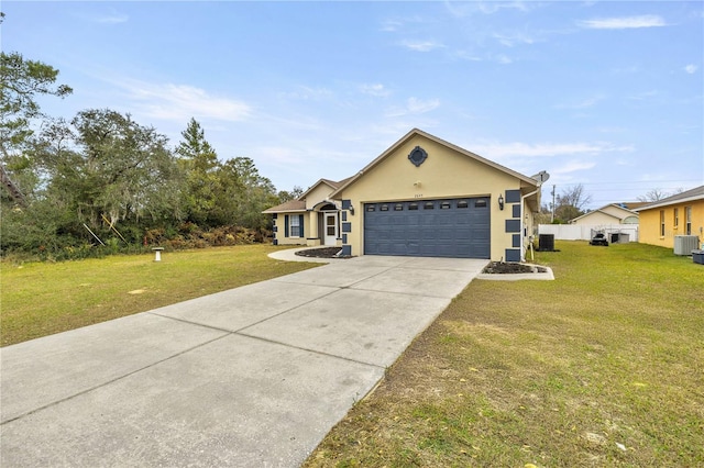 single story home featuring cooling unit, a garage, and a front yard