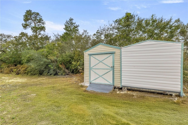 view of outbuilding featuring a yard