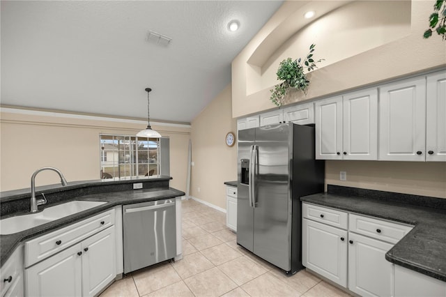 kitchen featuring appliances with stainless steel finishes, sink, white cabinetry, hanging light fixtures, and light tile patterned flooring