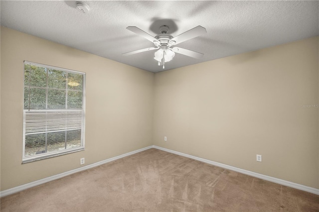 empty room featuring light carpet and ceiling fan