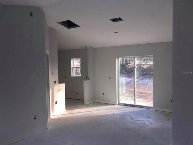 spare room featuring lofted ceiling