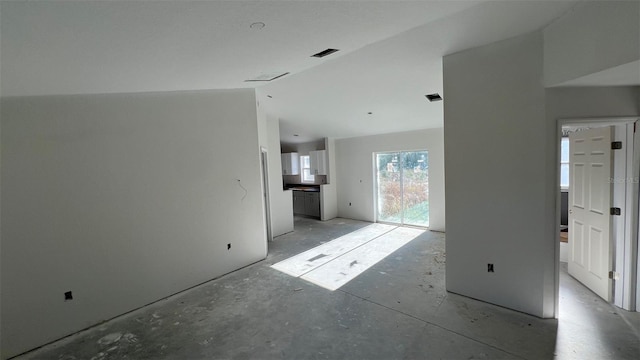 unfurnished living room featuring lofted ceiling