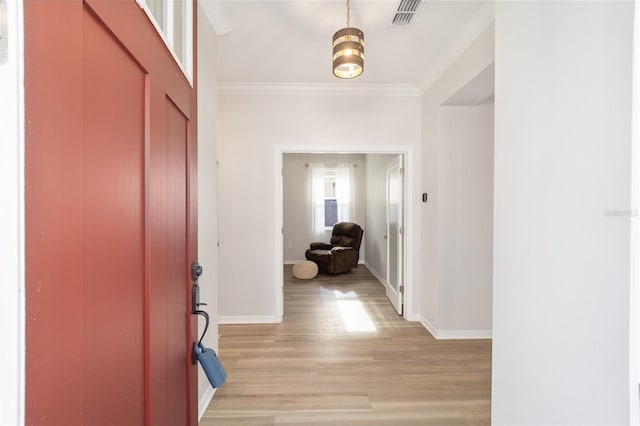 hallway featuring light hardwood / wood-style floors and crown molding