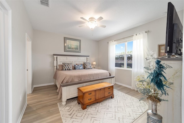 bedroom with ceiling fan and light hardwood / wood-style floors