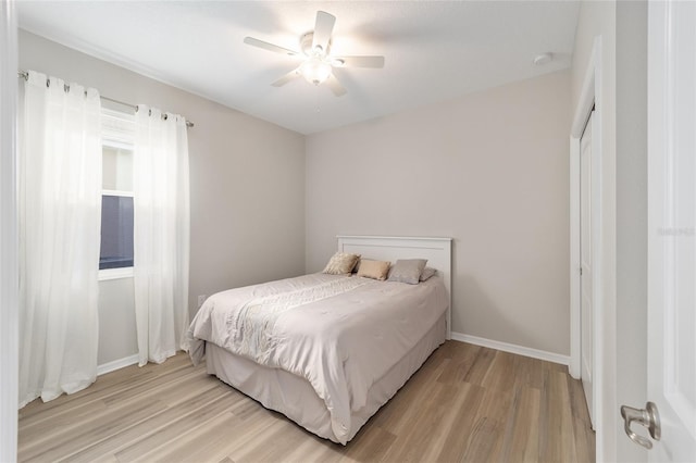 bedroom with ceiling fan and light hardwood / wood-style flooring