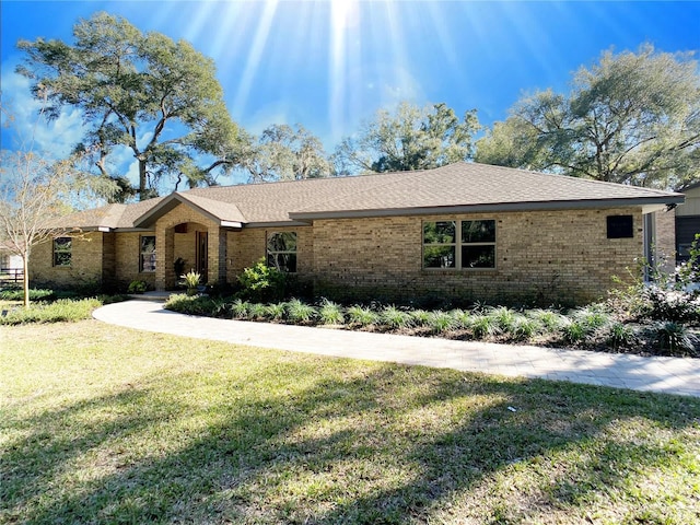 single story home featuring a front yard